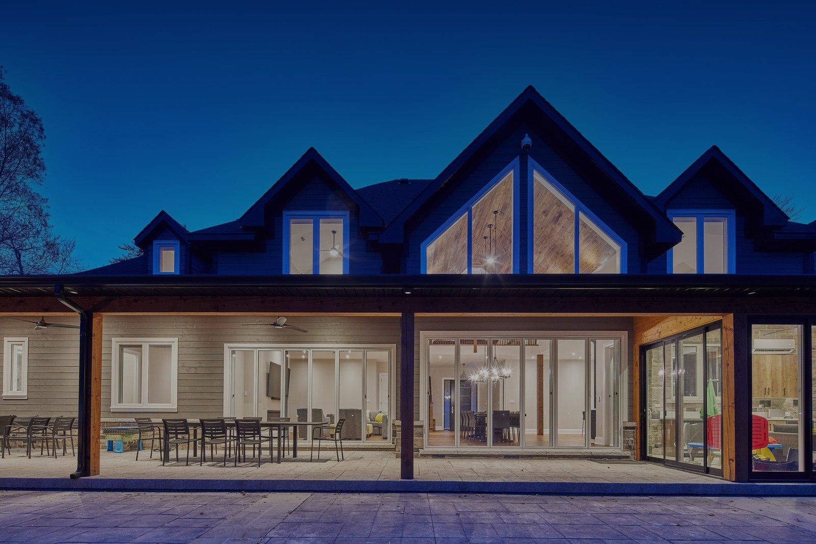 Large two-story home with tall gables at dusk